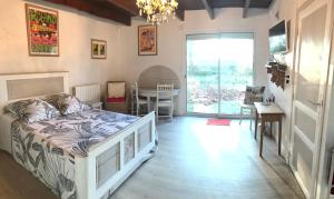 a bedroom with a bed and a dining room with a table at La Ferme Wessière in Oye-Plage