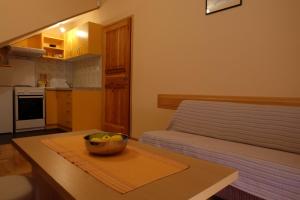 a kitchen with a bowl of fruit on a table at Apartment Jadranka in Trebinje