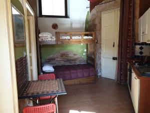 a room with a bed and a table and chairs at Bellavista in Acireale