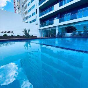 a swimming pool in front of a building at Xenon Urban Apartments in Maputo