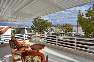 a patio with a table and chairs on a balcony at וילה דולב in Eilat