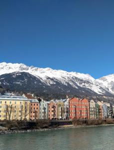 a city with buildings and snow covered mountains at Haus Georg in Innsbruck