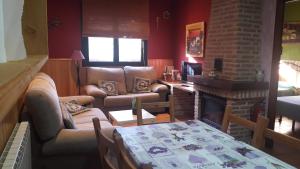a living room with a couch and a fireplace at La Casa de La Veleta Naturaleza y Calma in La Rinconada de Tajo +16 photos