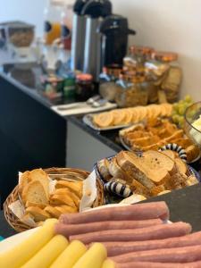 a table with a basket of bread and other foods at POUSADA MARITIMAR in Maragogi