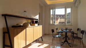 a kitchen with a table and chairs and a window at Zefiro Suites in Palermo