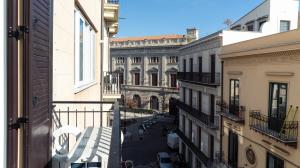 a view of a city street from a balcony at Zefiro Suites in Palermo
