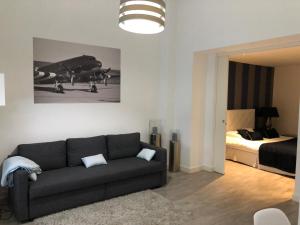 a living room with a couch and a bed at Victoria's House in Lille