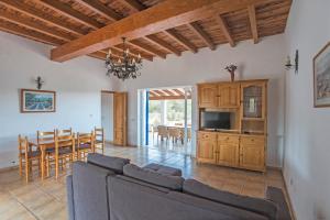 a living room with a couch and a table at CASA EUGENIO Cala Saona in Cala Saona