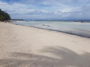 a shadow of a person on the beach at CasaKeja Inn in Panglao Island