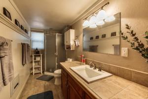 a bathroom with a sink and a toilet and a mirror at CREEK SIDE GETAWAY in Groveland +13 photos