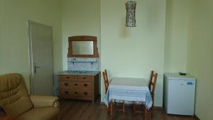 a room with a table and a dresser and a chair at Ferienwohnung Forsthaus in Neustadt am Rennsteig