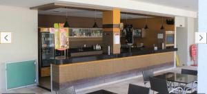 a bar in a restaurant with a counter and chairs at Flats - Veredas do Rio Quente in Rio Quente