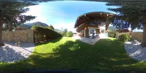 a house with a fence and a grass yard at Apartment Gredler Maria in Mayrhofen