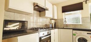 a kitchen with a sink and a stove top oven at Apple Garden A-2 in London
