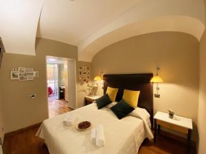 a bedroom with a large bed with white sheets at Hotel Giolitti in Rome