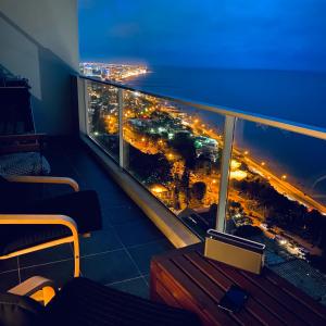 a balcony with a view of a city at night at Xenon Urban Apartments in Maputo