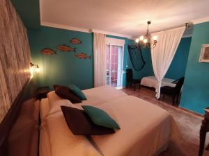 a bedroom with a bed with fish on the wall at Hotel Iris La Eliana in La Eliana