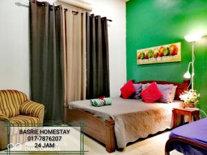 a bedroom with a bed and a green wall at Basrie Villa Pagoh - Mini Cinema , Private Pool , Wi-Fi , NetFlix in Muar