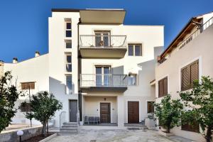 Cet appartement blanc dispose d'un balcon. dans l'établissement INAH Rooms, à Dorgali