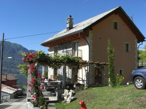 ein Haus mit einem roten Vogel, der davor steht in der Unterkunft Agriturismo Cantina Carrara in Gordola