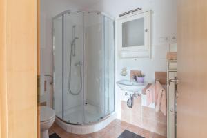a bathroom with a shower and a toilet and a sink at Apartments Valant in Bled