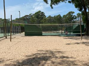 a tennis court with a net on a court at Green Park in Punta del Este