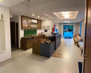 a lobby of a hospital with a counter and chairs at Hotel e Pousada Manguinho in Penha