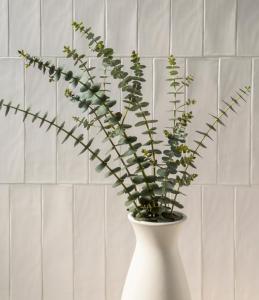 a white vase with a plant in it at MacArthur Place Inn & Spa in Sonoma