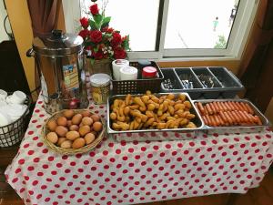 a red and white polka dot table with food on it at Khwanruen Fishing Resort in Ban Chang