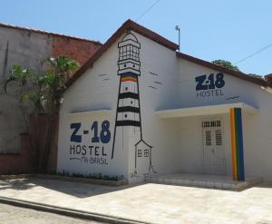 a building with a painting of a lighthouse on it at Z-18 Hostel in Barreirinhas