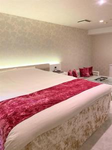Rúm í herbergi á Hotel Regent (Adult Only)