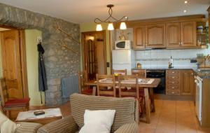 a kitchen and living room with a table and chairs at Mas Mallol in Puigcerdà