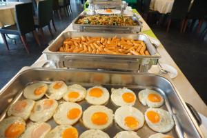 a buffet with eggs and pretzels and other food at แกรนด์ ฟอเรสท์ Grand Forest in Chanthaburi