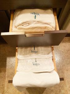 two white towels are sitting in a drawer at Hotel Venus Ritz (Adult Only) in Seto