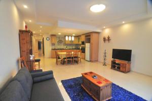 sala de estar con sofá azul y mesa en Superior Xlendi Lungomare Apartment, en Xlendi