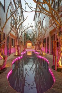 a canal with pink lights in the middle of a building at NORN Nimman13 Boutique Hotel Chiang Mai in Chiang Mai