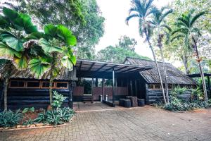 a building with palm trees in front of it at Baan Chai Dan in Thong Pha Phum +11 photos