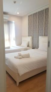 Postel nebo postele na pokoji v ubytování Harmony Resort Hotel