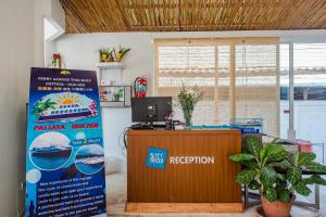 an office with a reception desk and a sign at Sleepeasy Hostel Hua Hin By Baankangmung in Hua Hin