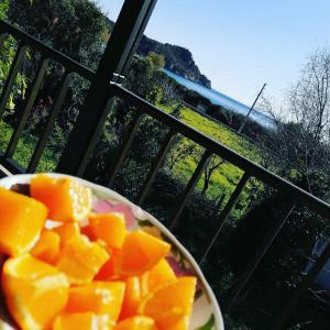 a bowl of oranges in front of a window at Sempati Apart in Mesudiye
