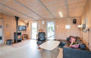 a living room with a couch and a table at Gorgeous Home In Ringkøbing With Sauna in Klegod