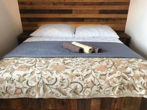 a bed with a wooden headboard and a blanket and a wooden at Apartmán Luky in Vyšné Ružbachy