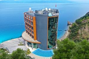 a hotel on top of a hill next to the water at BLUE MUDANYA HOTEL in Bursa
