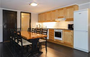 a kitchen with a wooden table and a white refrigerator at Nice Apartment In Hemsedal With Wifi in Hemsedal