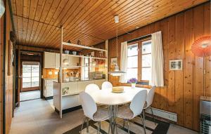a kitchen with a table and chairs in a room at 3 Bedroom Amazing Home In Aakirkeby in Vester Sømarken