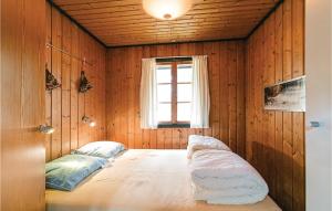 a bedroom with a bed in a room with a window at 3 Bedroom Amazing Home In Aakirkeby in Vester Sømarken
