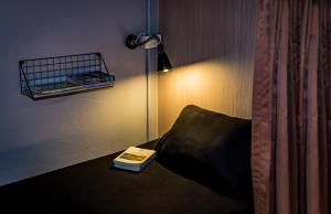 a lamp on a lamp post next to a bed at Mind Day Hostel Khaosan in Bangkok