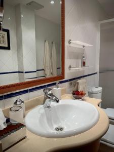 a bathroom with a white sink and a mirror at El Pino de Cerler in Cerler +17 photos