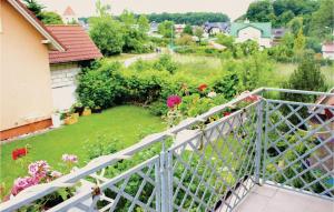 a balcony with a view of a garden at Holiday Home Rewal Olszynowa in Rewal