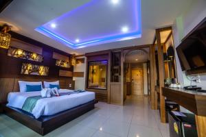 a bedroom with a large bed and a large window at ChaoKoh Phi Phi Hotel and Resort- SHA Extra Plus in Phi Phi Don
